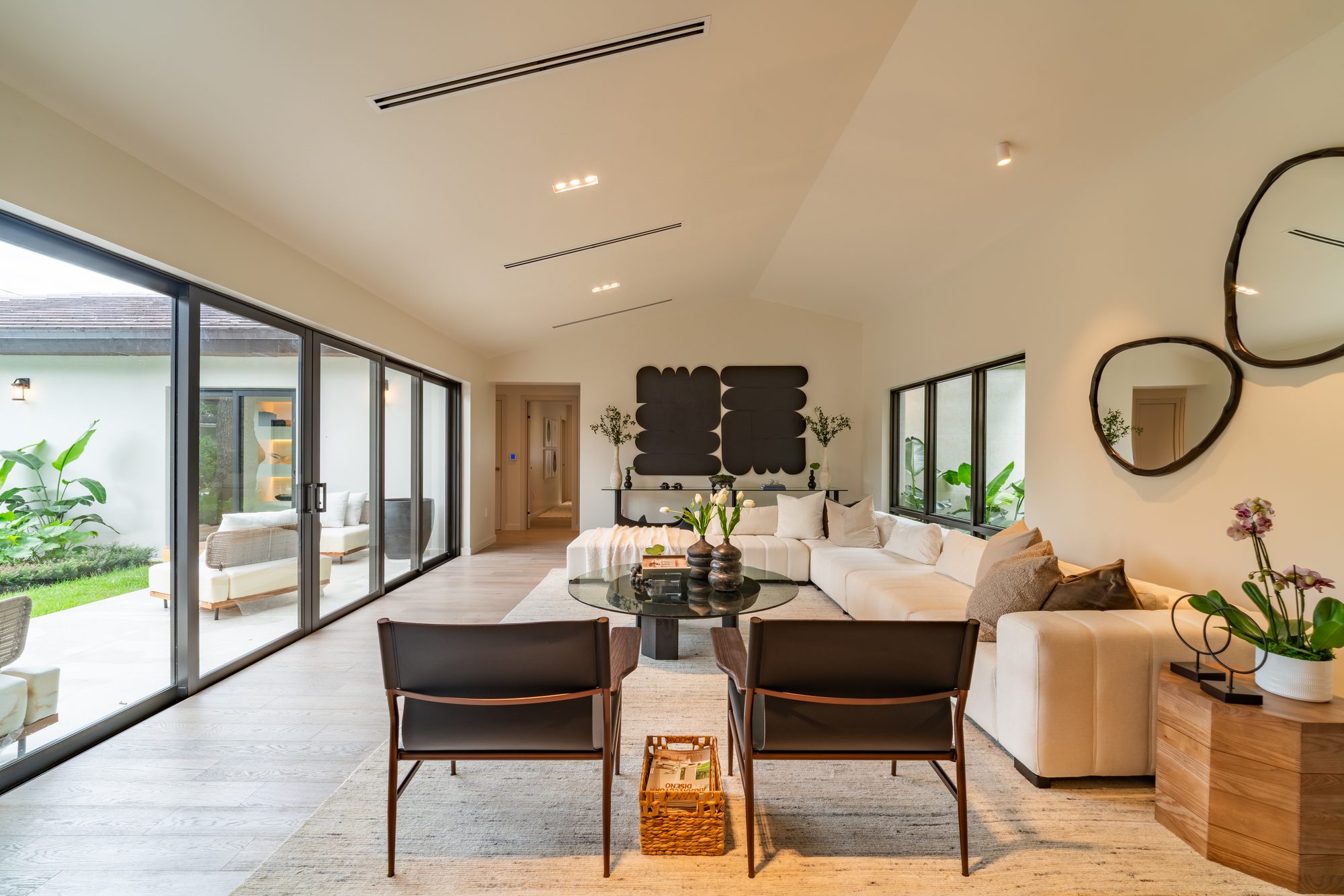 The living area with sliding doors framing the pool court